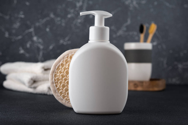 White empty shampoo or lotion bottle for mock-up in modern dark bathroom interior - Фото, изображение