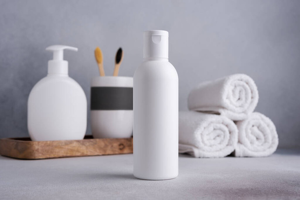White empty shampoo or lotion bottle for mock-up in Scandinavian bathroom interior - Foto, Imagen