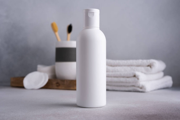 White empty shampoo or lotion bottle for mock-up in Scandinavian bathroom interior - Zdjęcie, obraz