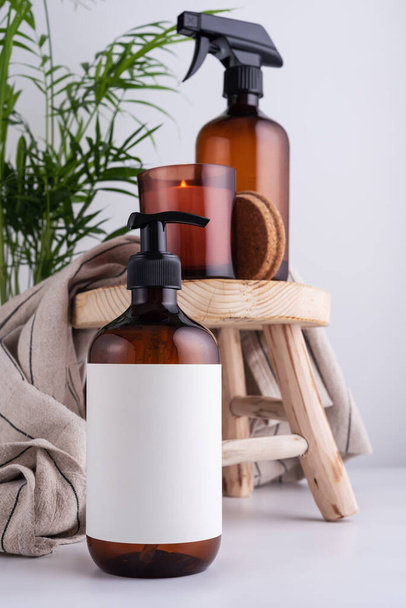 Eco-friendly brown dispenser with shower gel, liquid soap or shampoo on a wooden stool in the bathroom - Фото, зображення