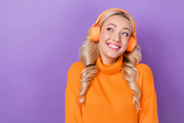 Photo of gorgeous cheerful lady beaming smile look empty space listen music headphones isolated on violet color background. - Fotó, kép