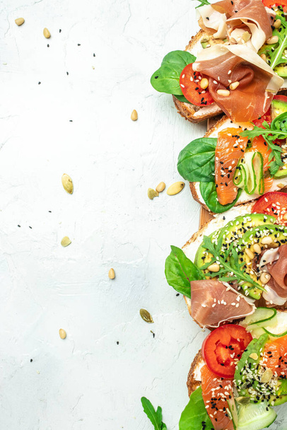 Open sandwich set with cream cheese, prosciutto, salmon, avocado and fresh greens. Keto, ketogenic diet, low carb, high good fat , healthy food. top view. - Photo, Image