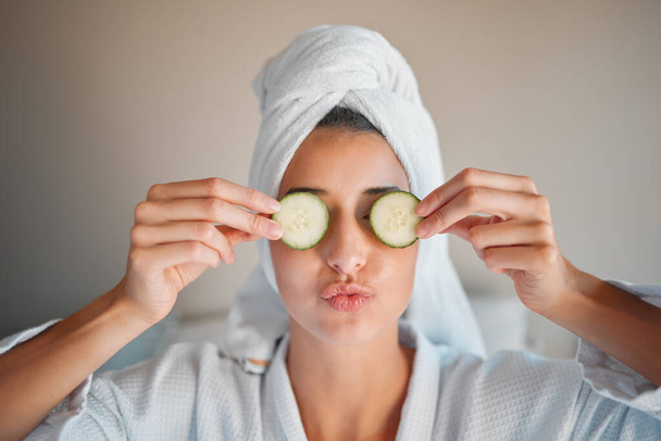 Self care, skincare and woman with cucumber on her face for a organic, cosmetic and natural skin routine. Beauty, vegetable and female doing a spa facial treatment for self love and to relax at home - Fotografie, Obrázek