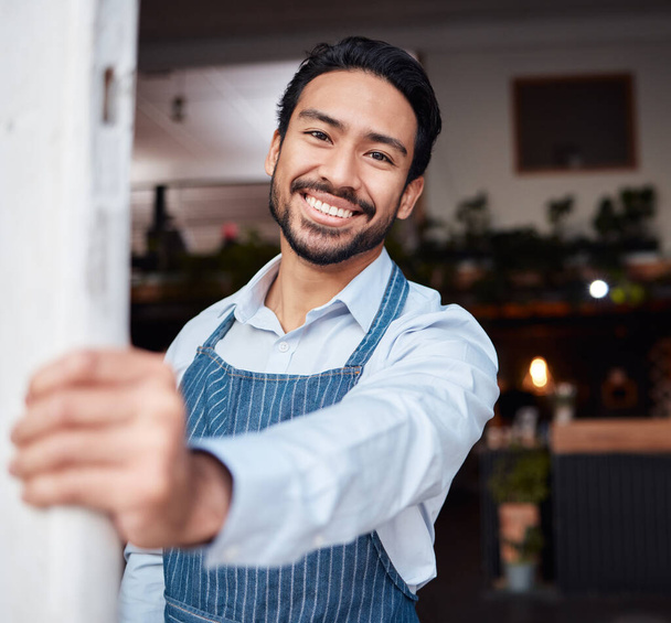 Happy, portrait and male entrepreneur of a cafe standing by the door to welcome customers. Confident, proud and face of a young man small business owner with success at his modern startup coffee shop. - Photo, Image