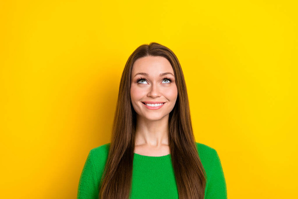 Portrait of gorgeous positive lady beaming smile look up above empty space isolated on yellow color background. - Fotó, kép