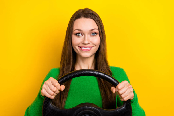 Photo of cheerful gorgeous lady beaming smile arms hold wheel isolated on yellow color background. - Valokuva, kuva