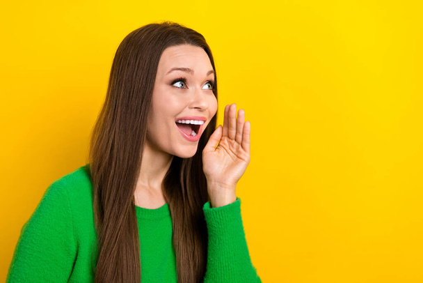 Photo of funny excited woman wear green sweater arms mouth shouting empty space isolated yellow color background. - Фото, зображення