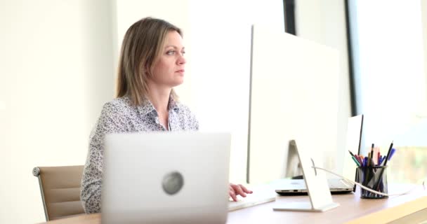 Business woman looking seriously at computer screen. Attentive focused manager working on computer in office - Footage, Video