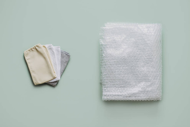 Recycling Fibers in the Textile Industry. Sustainable recycled cotton fiber. Many napkins fabrics made of recycled polyester synthetic fabric and bubble wrap. - Photo, image