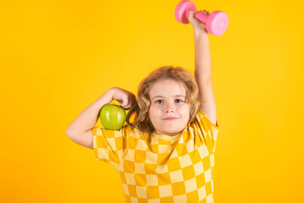 Child workout. Kid sport. Child exercising with dumbbells. Sporty child with dumbbell - Photo, Image