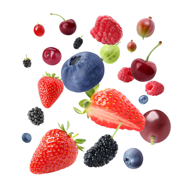 Many different fresh berries falling on white background - Fotó, kép