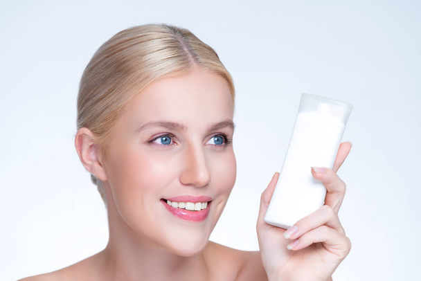 Closeup personable beautiful perfect natural skin woman hold mockup tube moisturizer cream for skincare treatment product advertising expressive facial and gesture expression in isolated background. - Foto, imagen