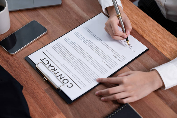 Closeup hand signing contract document with pen, sealing business deal with signature. Businesspeople finalizing business agreement by writing down signature on contract paper. Enthusiastic - Foto, imagen