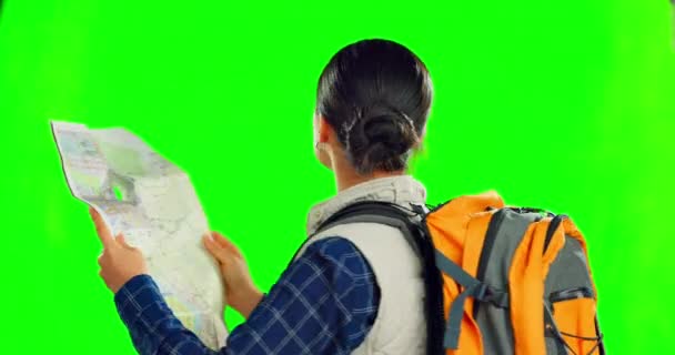 Asian woman, map and backpack on green screen for travel, location or destination against a studio background. Female adventurer backpacking with navigation of lost or confused traveler on mockup. - Footage, Video
