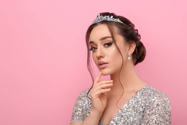 Beautiful young woman wearing luxurious tiara on pink background, space for text - Photo, Image