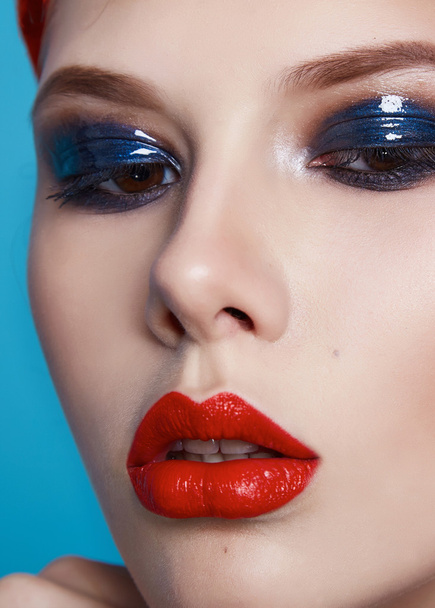 Beautiful sexy woman color makeup red lips blue eyes cosmetics - Foto, afbeelding