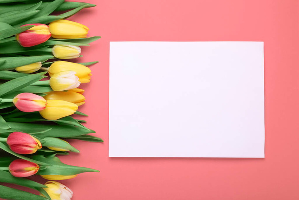 Beautiful tulips and blank card on red background, flat lay - Valokuva, kuva