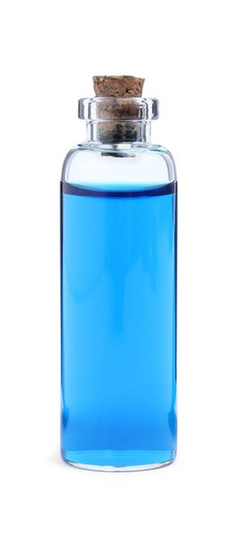 Glass bottle of light blue food coloring on white background - Φωτογραφία, εικόνα