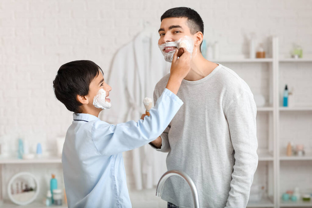 Morning of father and his little son shaving in bathroom - 写真・画像