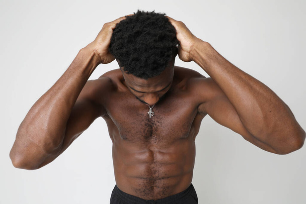 African American athletic man with doing neck stretching exercises. Mock-up. High quality photo. - 写真・画像