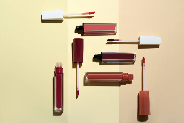 Composition with different liquid lipsticks on color background - Photo, Image