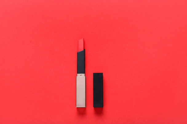 Beautiful lipstick on red background - Foto, Imagen