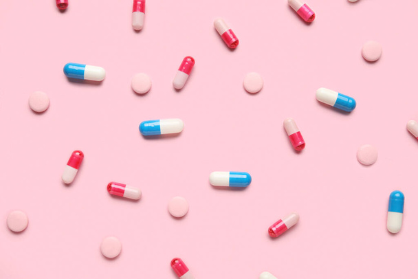Different pills on pink background - Foto, Imagem