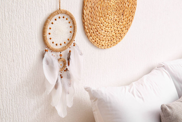 Dream catcher hanging on light wall in bedroom - Photo, Image