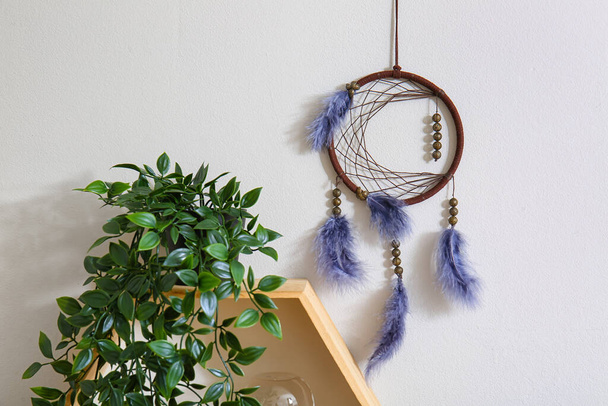 Dream catcher hanging on light wall in room - Photo, Image