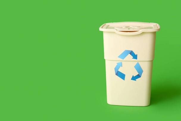 Container for garbage on green background. Recycling concept - Fotó, kép