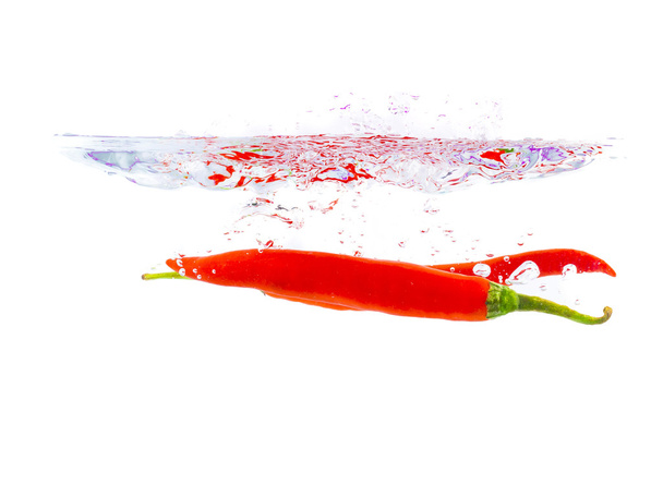 chilli dropping in water surface - Photo, Image