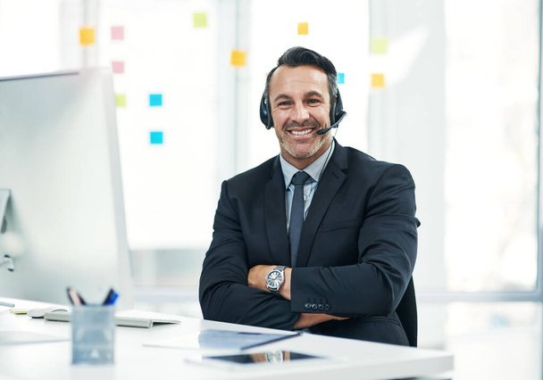 Ive been in the sales business for years. Portrait of a mature businessman wearing a headset while working in an office - Foto, Imagem