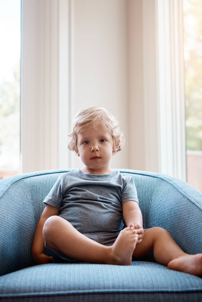 Hes too adorable for words. Portrait of an adorable little boy playing sitting on a sofa at home - Photo, Image