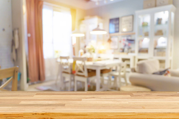 Wooden tables, wooden shelves in the foreground. Defocused image of shop or cafe with bokeh coloful lights background. living room interior blurred background - Фото, зображення