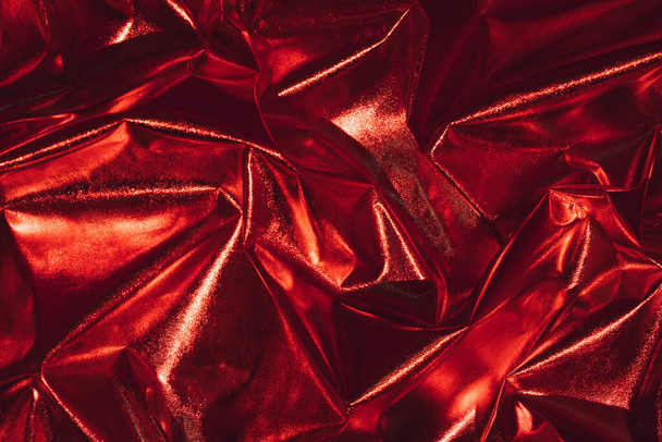 Abstract red crumpled foil background. Minimal Christmas, love or party concept. - Photo, Image