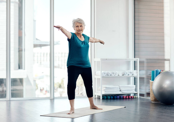 Mantenha-se ativo à medida que envelhece. uma mulher sênior praticando ioga em um estúdio - Foto, Imagem