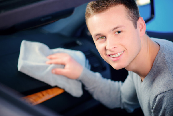 Handsome man cleaning his car - Photo, Image