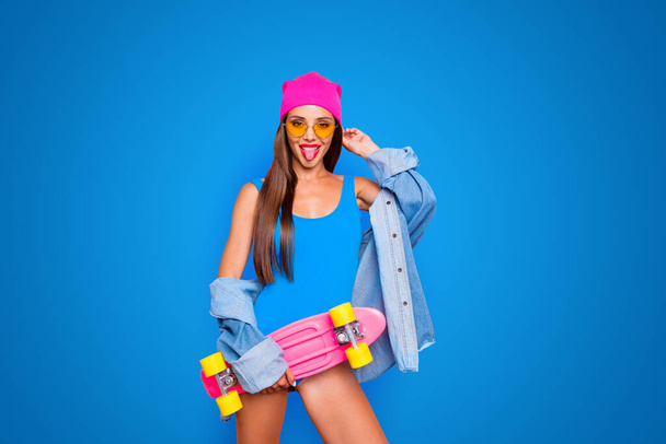 Happiness lifestyle leisure hobby skater people person concept. Photo portrait of beautiful funky attractive charming girl sticking tongue out holding longboard isolated bright background. - Foto, afbeelding