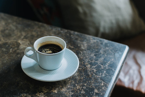 Cup of black coffee on a table in a cafe. Selective focus. Place for text. - Foto, Imagen