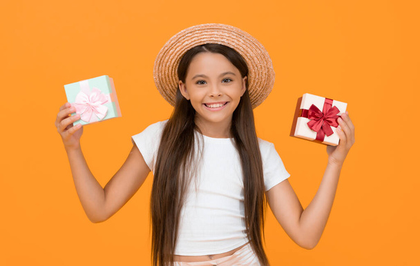 smiling teen girl hold present box on yellow background. - Photo, image