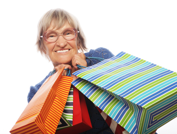 Happy senior woman with shopping bags - Фото, изображение