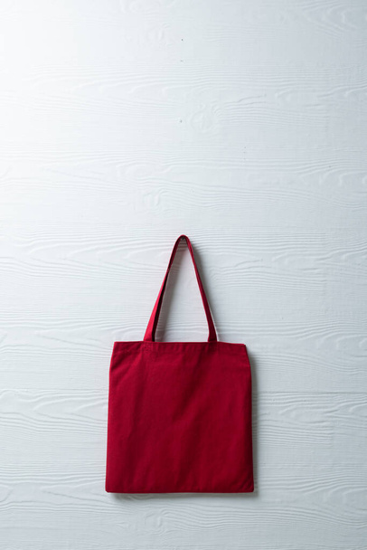 High angle view of red canvas bag with copy space on grey background. Bags and fashion concept. - Fotografie, Obrázek