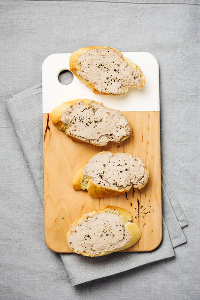 Baguette with liver pate on a linen tablecloth. - Photo, Image
