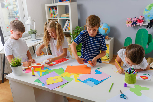 children making paper handicrafts at kindergarten  - Fotoğraf, Görsel