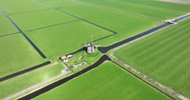 Atemberaubendes Drohnenvideo, das eine traditionelle Polder-Windmühle in den Niederlanden zeigt, ein ikonisches Symbol holländischen Erbes und Erfindungsreichtums. - Filmmaterial, Video