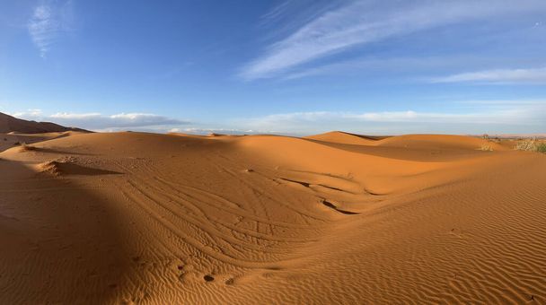 Merzouga, Erg Chebbi dunes, Morocco, Africa: panoramic view of the dunes in the Sahara desert, grains of sand forming small waves on the beautiful dunes at sunset  - Photo, Image