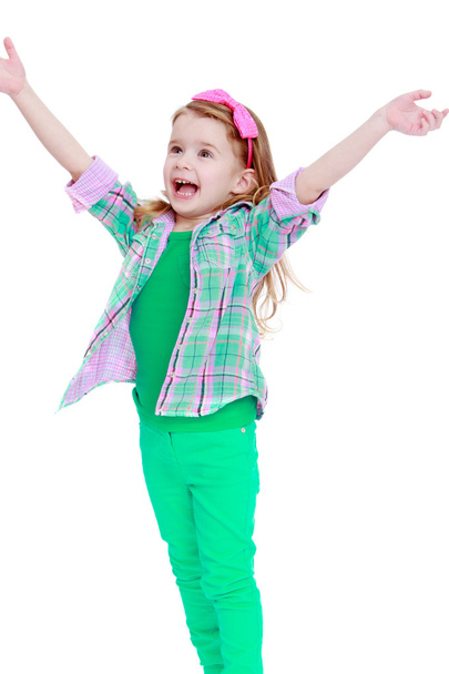 happy little girl jumping hands wide apart. - Foto, Imagen