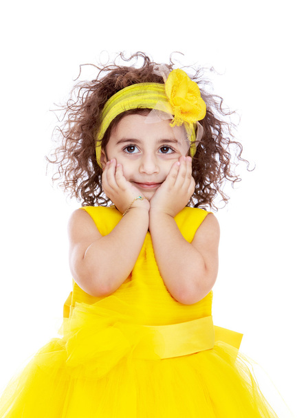 Close-up of elegant little girl in a bright yellow dress. - Photo, Image