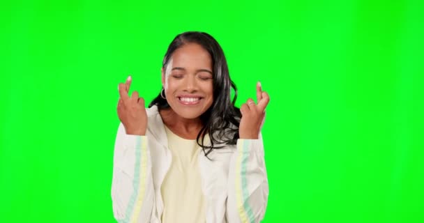 Happy woman, fingers crossed and excited on green screen, background and studio for good luck. Female model hope for winning vote, wishing and lucky lottery prize with emoji sign, hands and smile. - Footage, Video
