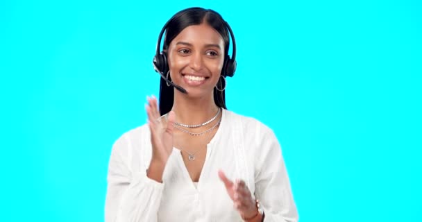Call center, telemarketing or Indian woman in studio for communication isolated on blue background. Customer services, crm or b2b girl in headset helping, talking or explaining at technical support. - Footage, Video
